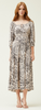 A woman wears an ivory dress with mixed animal print in black. It has 3/4 length sleeves and a square neckline.